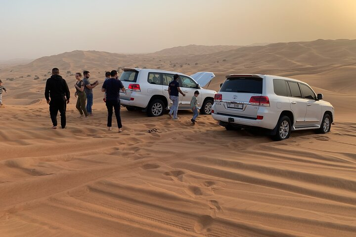 Explore the stunning desert landscape while dune bashing in a Toyota SUV mingling with fellow adventurers and getting ready for memorable activities under the golden sands of Dubai.